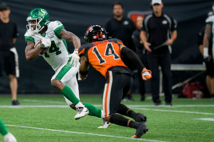 Aug 26, 2022; Vancouver, British Columbia, CAN; Saskatchewan Roughriders wide receiver Tevin Jones (14) runs with the ball against the BC Lions in the second half at BC Place. Mandatory Credit: Bob Frid-USA TODAY Sports